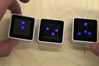 To imitate the classical fidgeting favorite Newton's Cradle, NYU researchers created Rock the Cradle, in which participants rock their Sifteo cubes to impart virtual velocity to "masses" (dots) and physically rearrange the virtual masses.