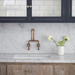 Marble sink, glass display cabinets, copper tap