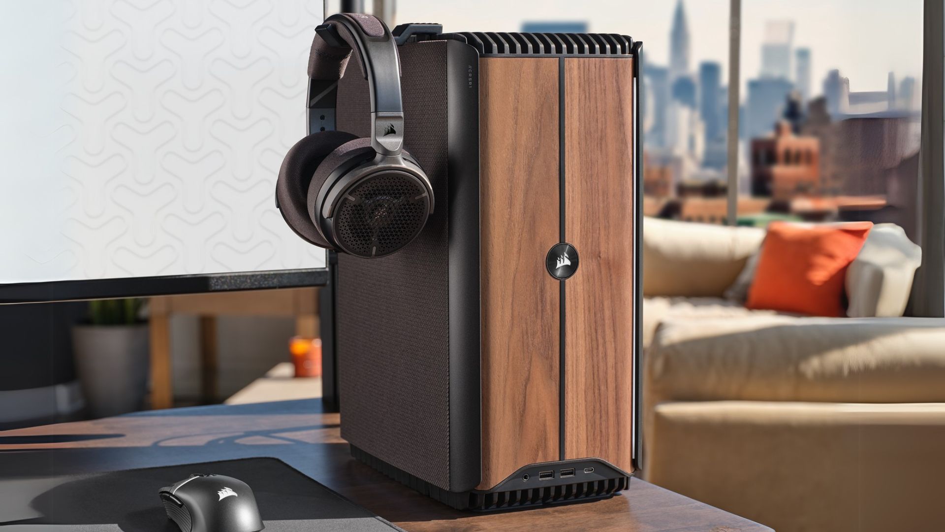 The wooden Corsair One i600 on a desk, showing a headset hook on its side