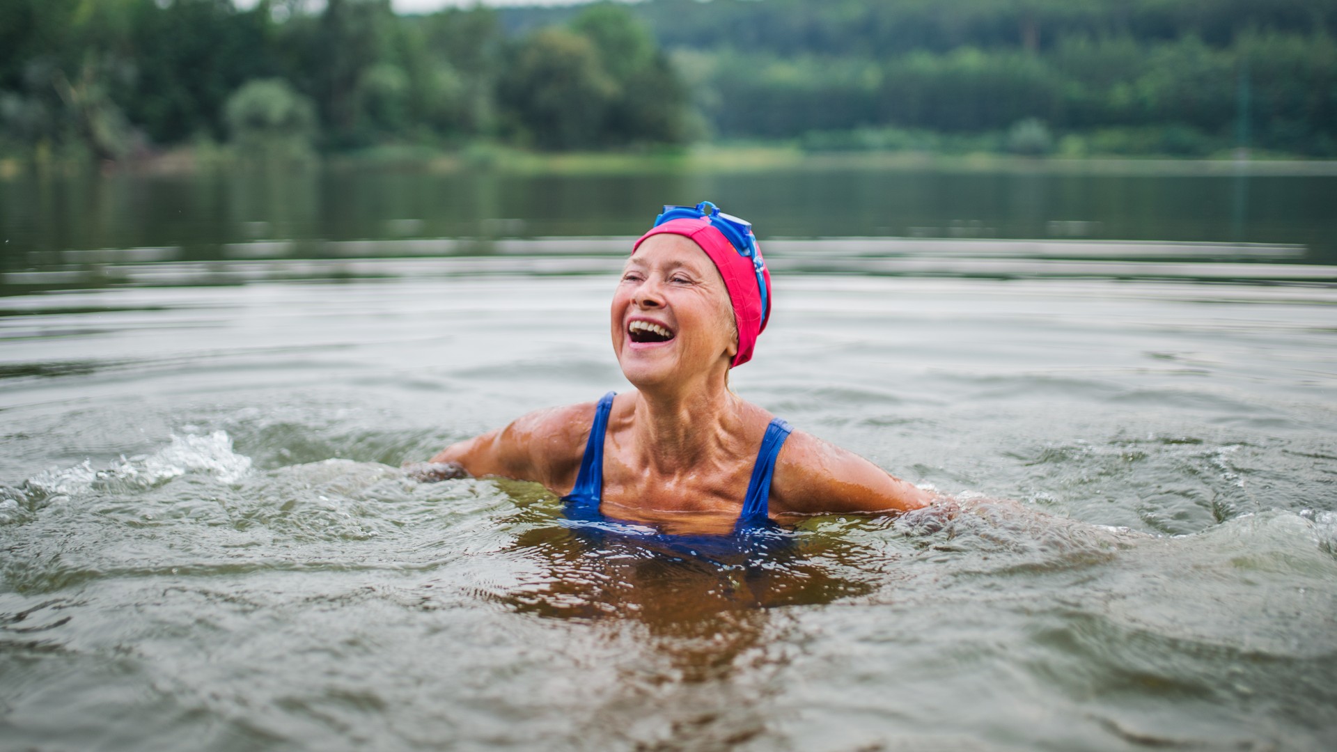Senior woman swimming in a lake