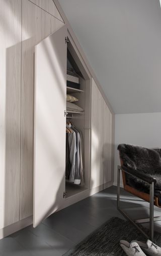fitted wardrobe under the eaves in a bedroom sloping wall