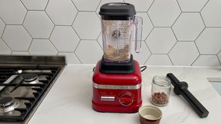 KitchenAid High Performance Series Blender KSB6060 being used to blend nuts on a kitchen countertop
