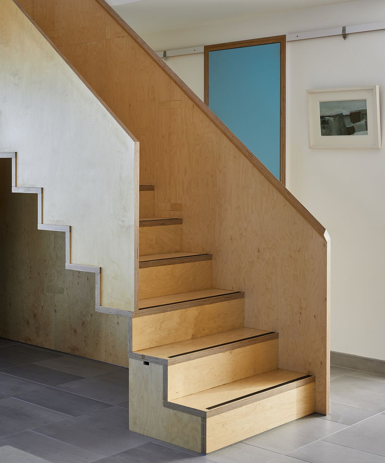 A new floating staircase made of wood in a renovated seaside property