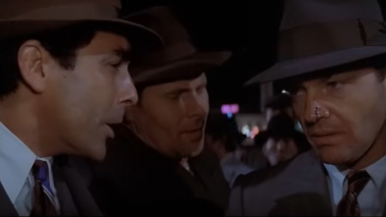 Three men have a conversation at the end of Chinatown.