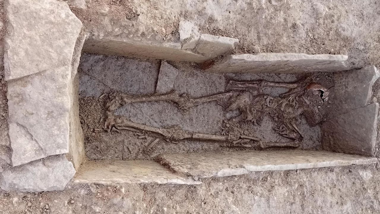 A grave with a skeleton inside
