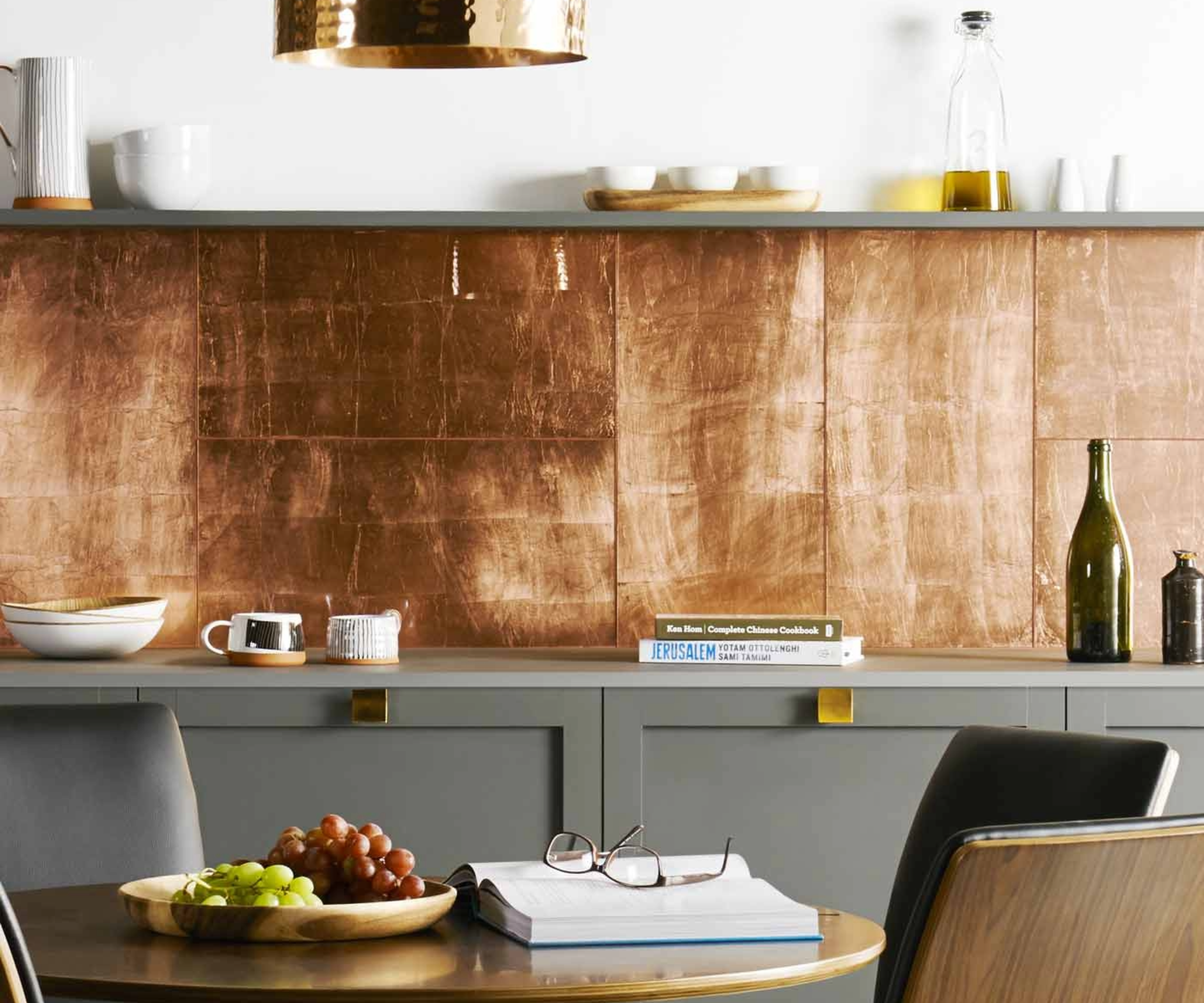 Metallic kitchen wall tiles against khaki cabinets