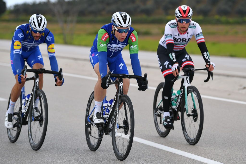 Fabio Jakobsen wears the green sprint jersey underneath his gilet