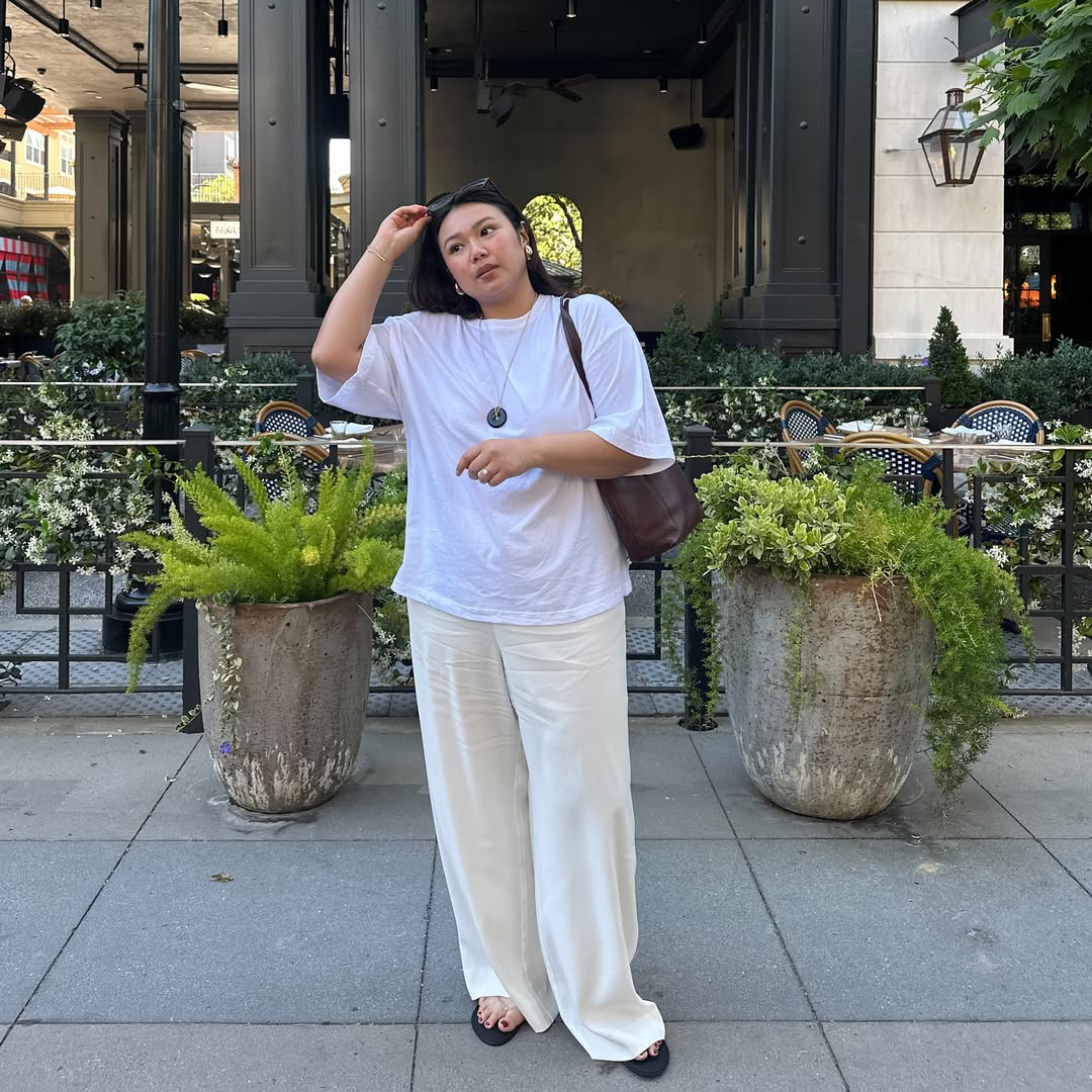 An influencer wearing a top and pants. 
