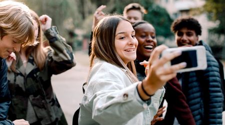 Teenagers taking a selfie while protected by parental controls
