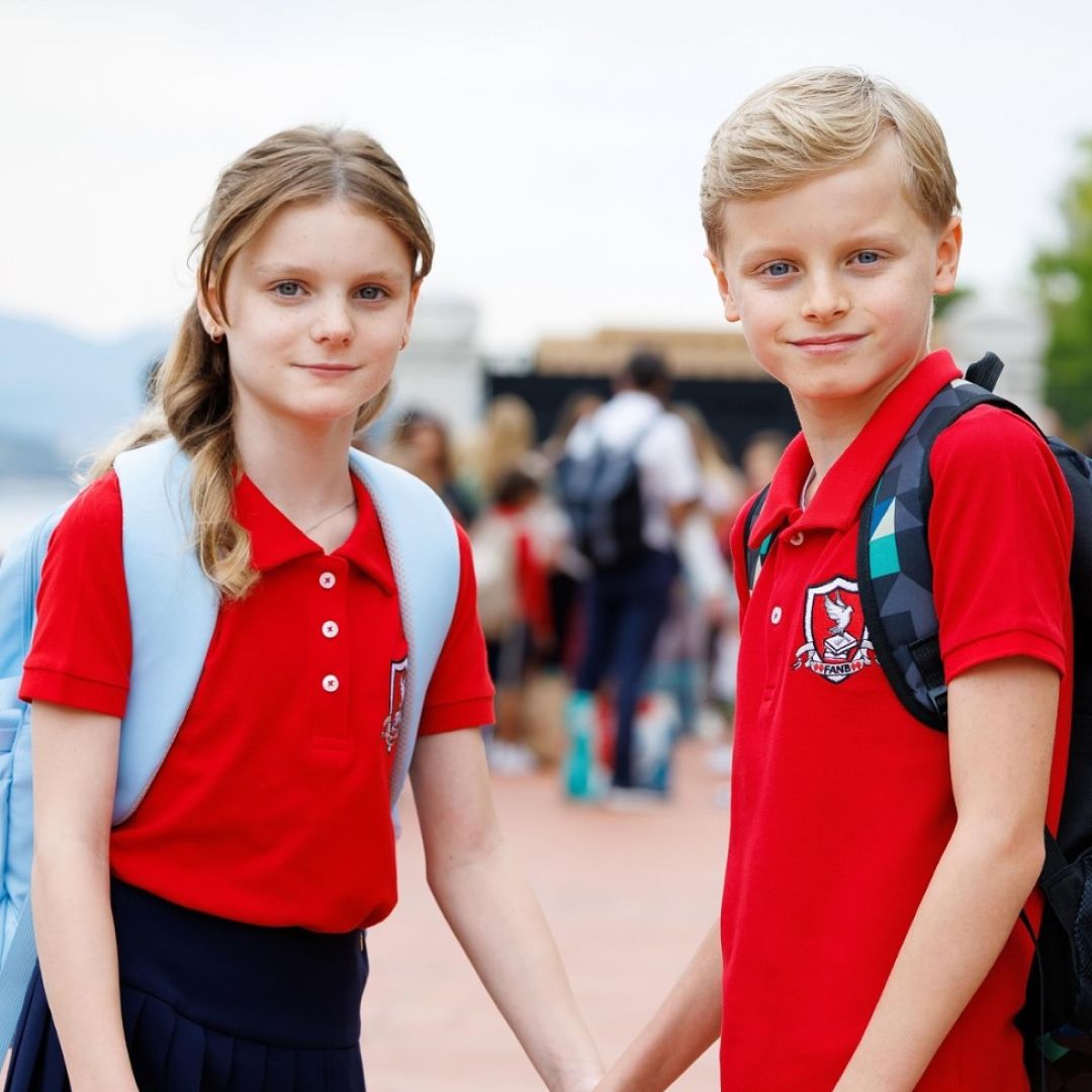 Princess Gabriella and Prince Jacques posing in red school uniforms and backpacks