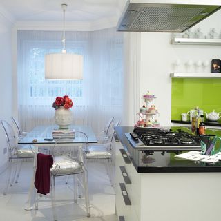kitchen and dining area with white wall and kitchen counter and dining table