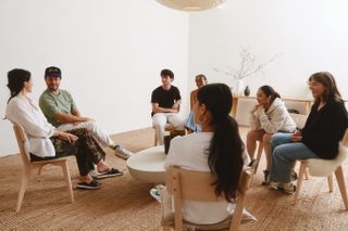A photo of 7 Peoplehood members sitting at a Gather at the flagship studio.