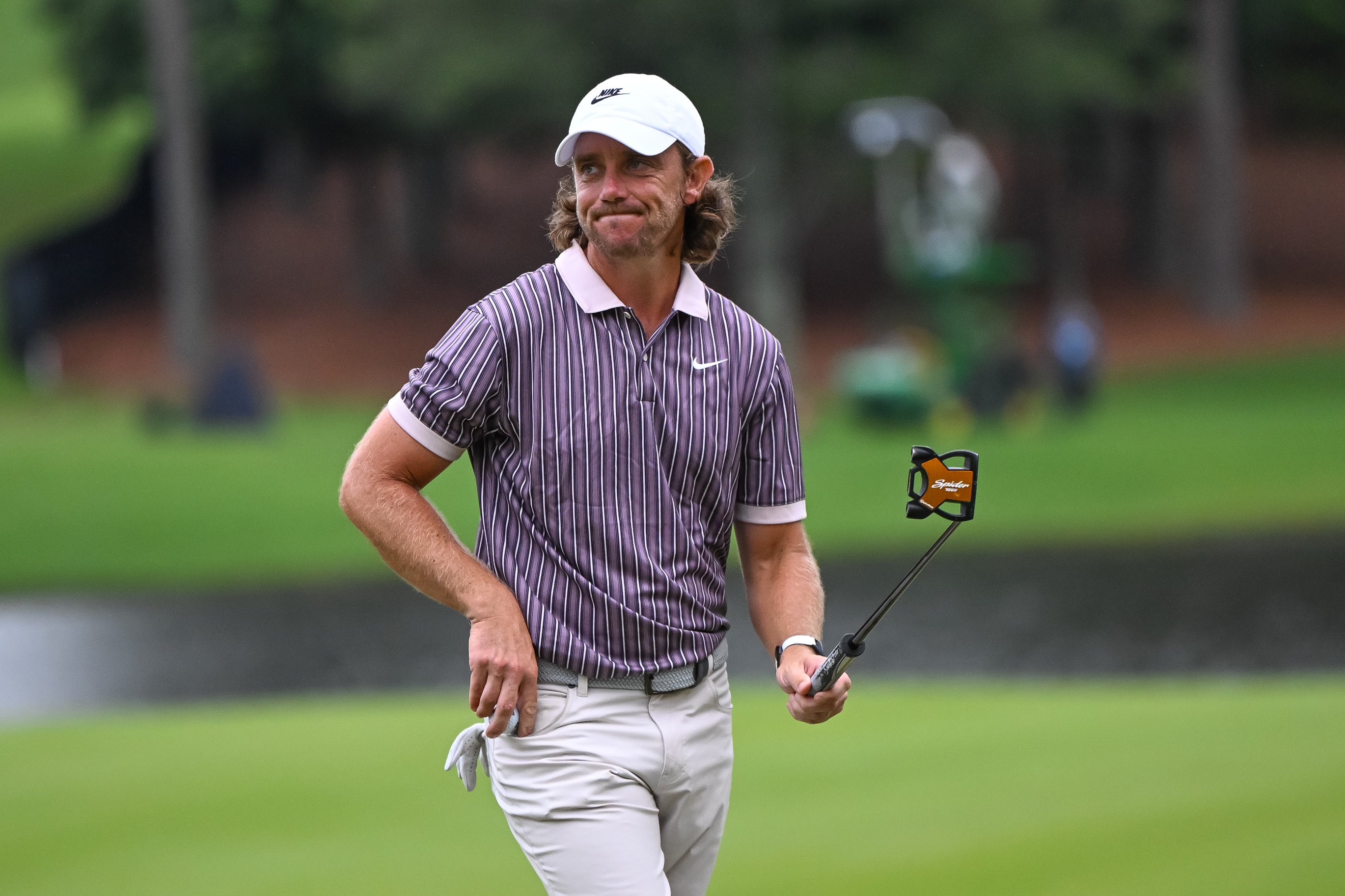 Tommy Fleetwood holds his putter in the air