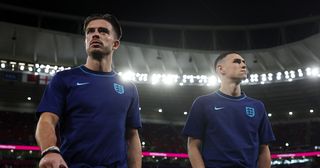 Jack Grealish and Phil Foden of England look on prior to the FIFA World Cup Qatar 2022 Group B match between Wales and England at Ahmad Bin Ali Stadium on November 29, 2022 in Doha, Qatar.