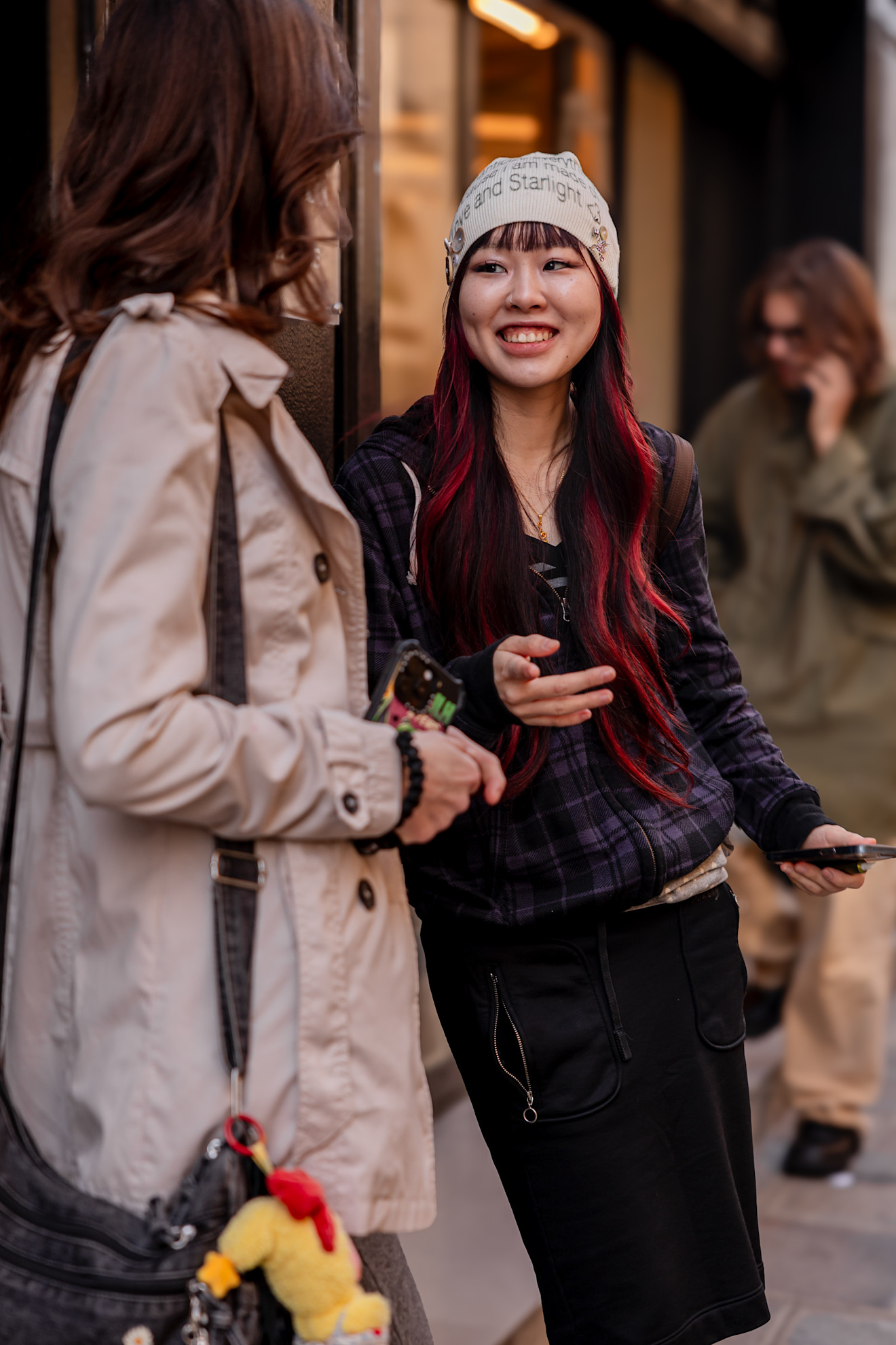 a woman with red hair in a white beanie hat