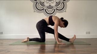 A woman doing half splits with rounded back