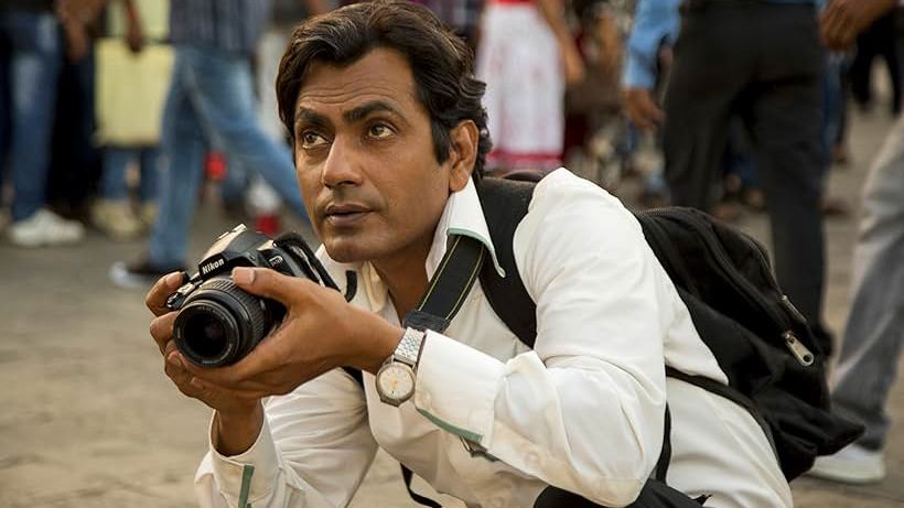 Nawazuddin Siddiqui holding a camera in the film &quot;The Photograph&quot;