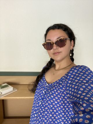 Woman wearing sunglasses and a blue dress in Palm Springs.