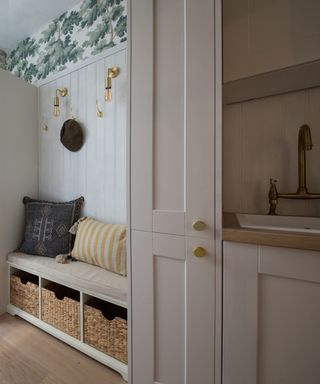 Sleek Edison Wall Light - Brass, with neutral cabinetry, and a bench in the entryway and a sink to the right
