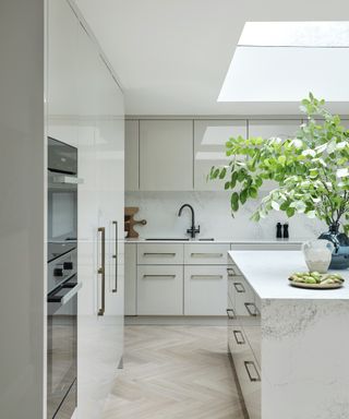 grey gloss kitchen with chevron wood floors