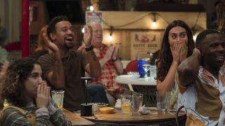 Anthony and other Company Retreat cast members looking surprised at a table in Jury Duty Presents Company Retreat