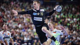 Fuechse Berlin's Danish right back #19 Mathias Gidsel in action during the EHF Handball Champions League Final 4 gold medal match between Fuechse Berlin and SC Magdeburg in Cologne, western Germany on June 15, 2025.