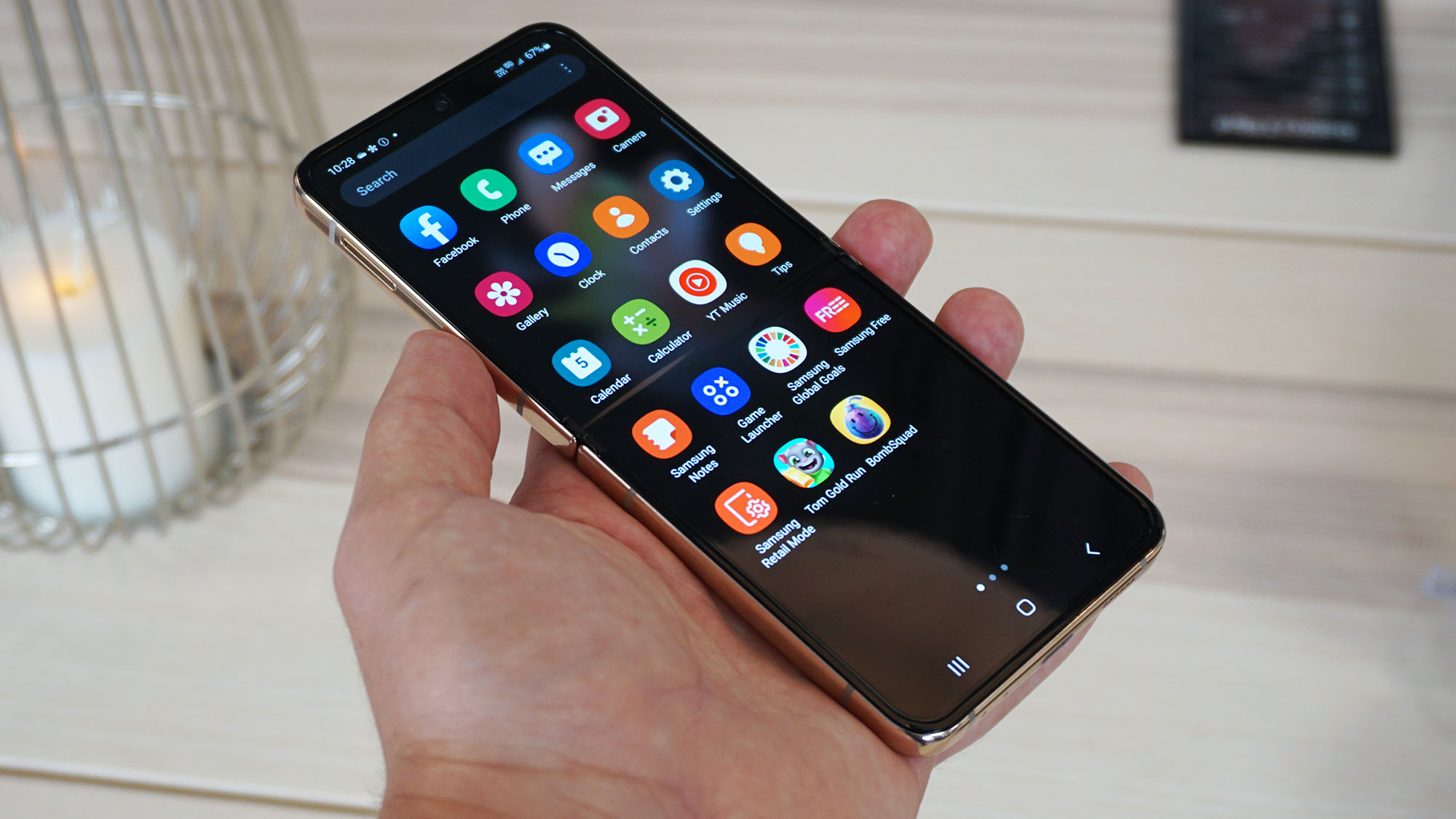 Samsung Galaxy Z Flip 4 Hands angled on beige front