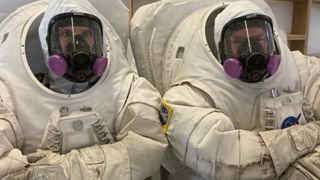 two astronauts in spacesuits