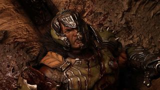 Doom Slayer's helmet cracks as he lays on the floor looking angry in a screenshot from Doom: The Dark Ages | Revelations