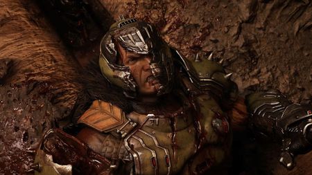 Doom Slayer's helmet cracks as he lays on the floor looking angry in a screenshot from Doom: The Dark Ages | Revelations
