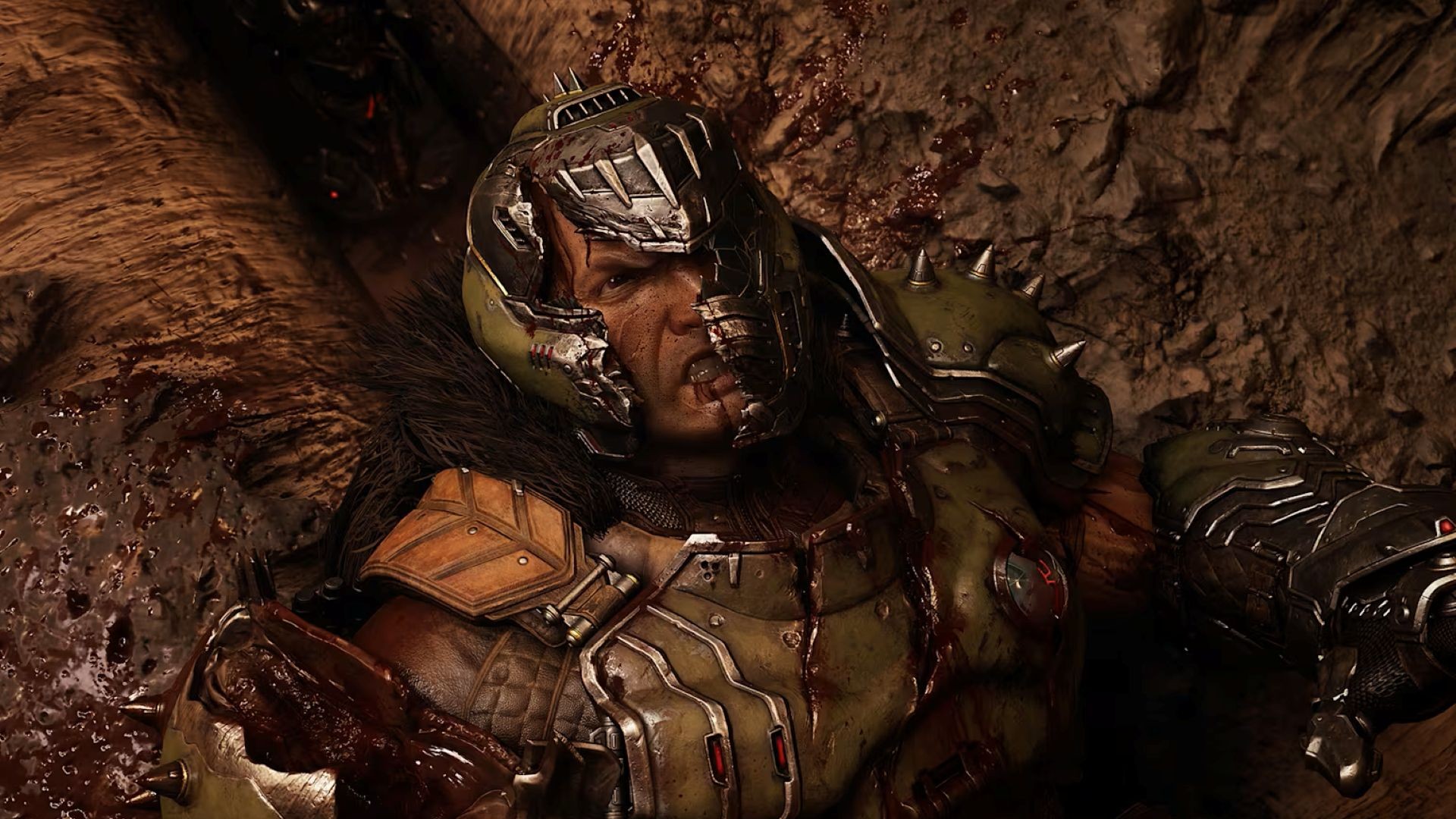 Doom Slayer's helmet cracks as he lays on the floor looking angry in a screenshot from Doom: The Dark Ages | Revelations