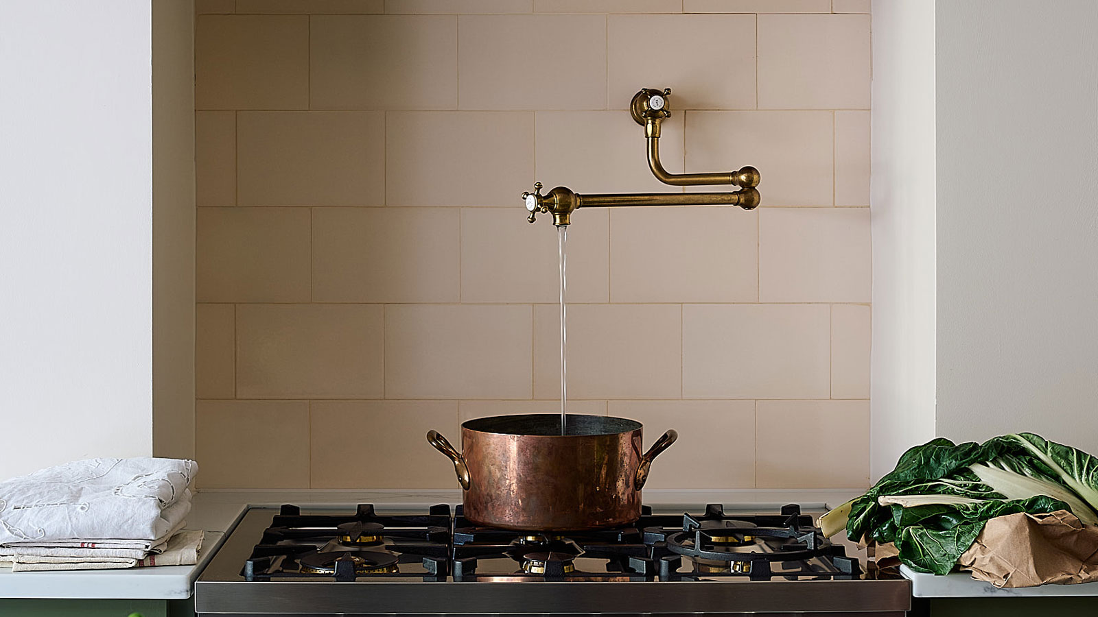 antique brass pot filler over has hob filling large copper pot