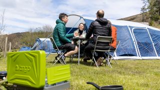 Campers sitting outside their tent