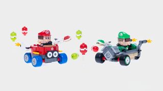 Lego Baby Mario and Baby Luigi in karts, surrounded by balloons and shells, against a plain background