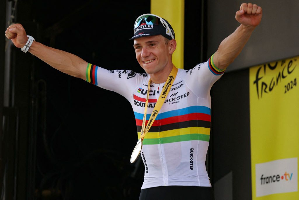 Soudal Quick-Step team's Belgian rider Remco Evenepoel celebrates on the podium after winning the 7th stage of the 111th edition of the Tour de France cycling race, 25,3 km individual time trial between Nuits-Saint-Georges and Gevrey-Chambertin, on July 5, 2024. (Photo by Thomas SAMSON / AFP)