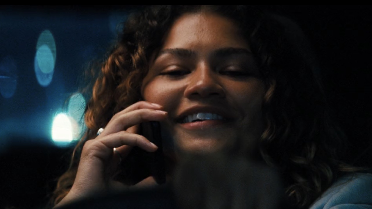 Rue smiling on the phone talking to Fez from prison.
