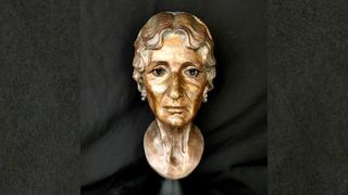 Bronze sculpture of a reconstruction of a female mummy aged between 50 and 60.