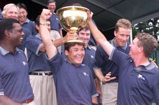 Shigeki Maruyama celebrates with the Presidents Cup trophy on his head