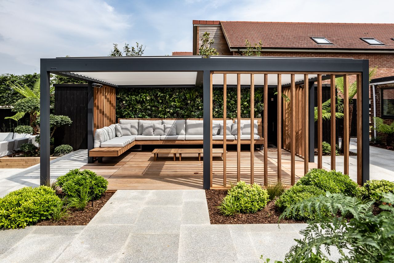 modern pergola with floating benchseat and decking that retracts to reveal hot tub