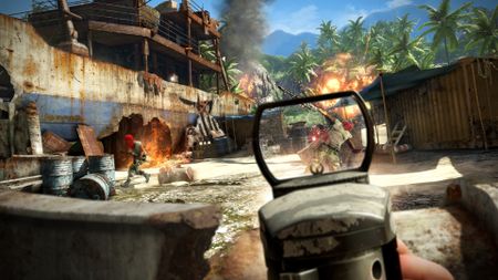 Aiming down laser sights at enemies with a rifle in Far Cry 3. A rusted boat is in the background with a fire happening nearby. Further back is jungle, with an explosion