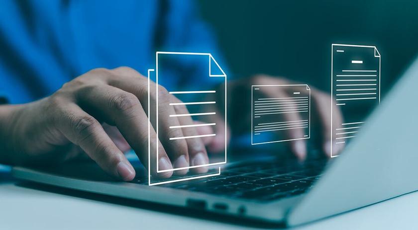 Picture of a hand typing on a laptop from the IAB website page for the new terms and conditions