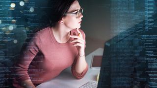 Concept image of a female software developer sitting at computer station using open source Redis alternative, Valkey