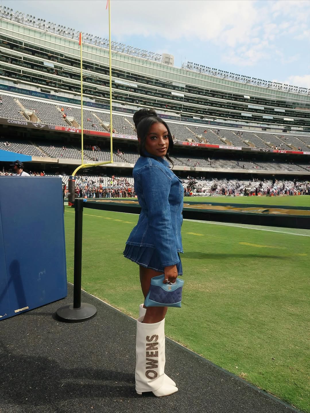 Simone Biles attended her husband&#039;s football game in the ultimate game day look: a denim skirt set, custom boots, and a Chanel bag