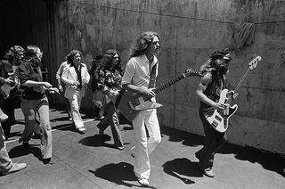 Lynyrd Skynyrd approach the stage at the Oakland Coliseum in 1976 in Oakland, California.