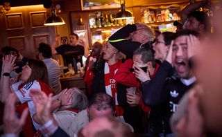 Arsenal fans react whilst watching the UEFA Champions League 2024/25 Semi Final Second Leg Match against PSG in The Drayton Park pub on May 07, 2025 in London, England.