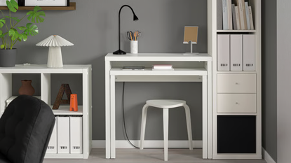 a room with a white desk, a white bookshelf, and a small white console table