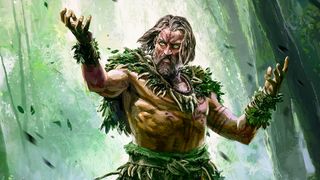 Promotional key art of Path of Exile 2's druid class. A man adorned with leaves, branches, and bones raises his hands in the air as if to summon a spell.
