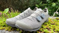 A pair of the Rapha Pro Team Powerweave gravel shoes sitting on greenary