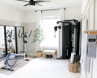 a home gym with storage, mirror wall and floor space - Jenna Pierce