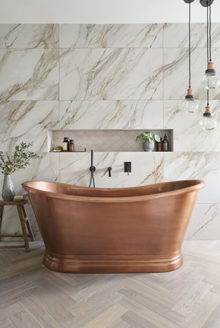 copper boat bath in marble bathroom